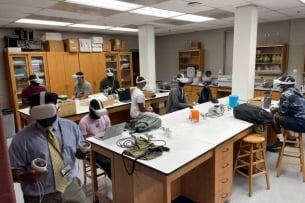 Morehouse College students utilizing the meta headsets in a microbiology class.